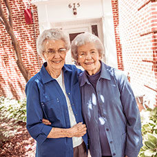 Two women smiling. Links to Gifts by Estate Note